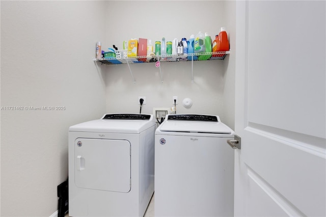 washroom featuring washer and clothes dryer