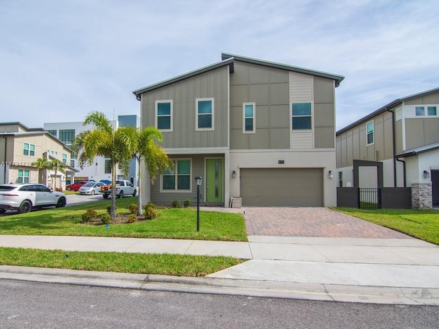 view of front facade with a front yard and a garage