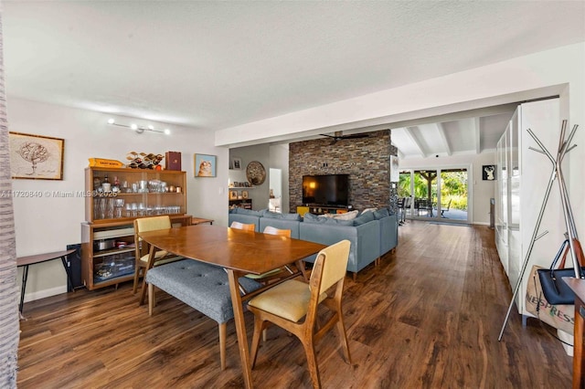 dining space featuring wood finished floors, vaulted ceiling with beams, and baseboards