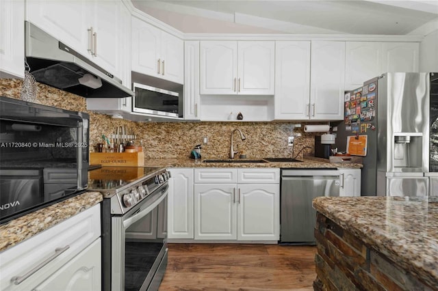 kitchen with a sink, dark wood finished floors, white cabinetry, under cabinet range hood, and appliances with stainless steel finishes