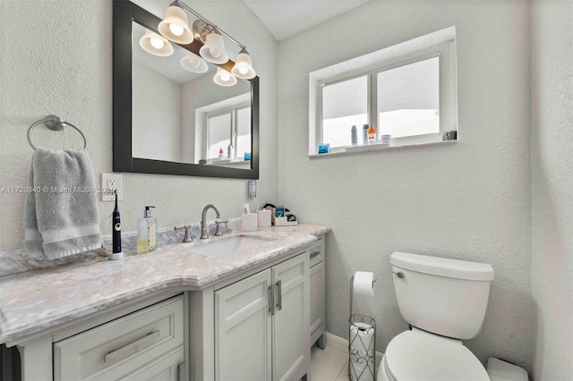 bathroom featuring toilet and vanity