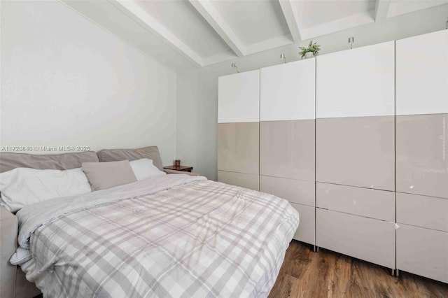 bedroom with lofted ceiling with beams and dark wood-type flooring