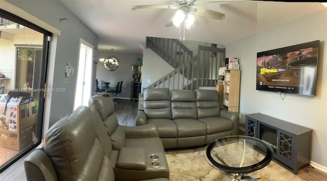 living room featuring ceiling fan with notable chandelier, hardwood / wood-style flooring, and a healthy amount of sunlight