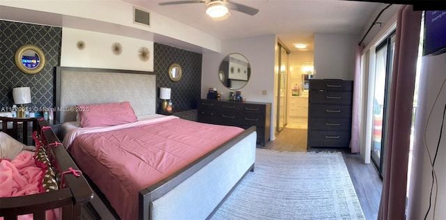 bedroom with hardwood / wood-style flooring and ceiling fan