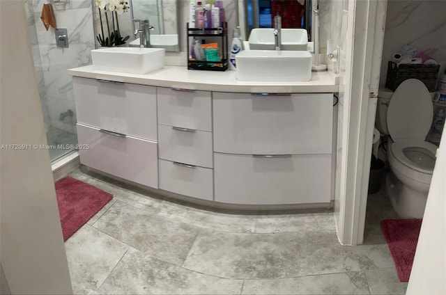 bathroom featuring an enclosed shower, vanity, and toilet