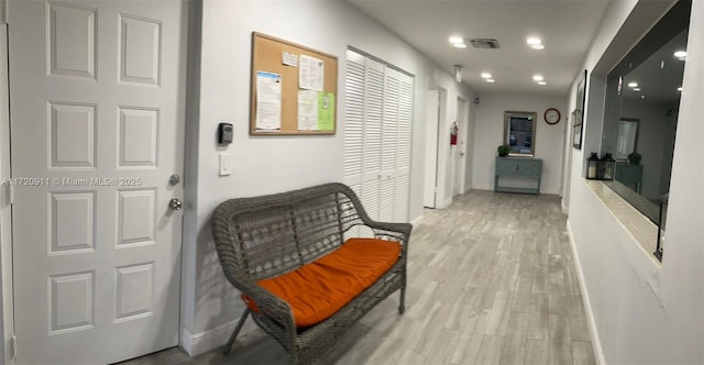 corridor with light hardwood / wood-style floors