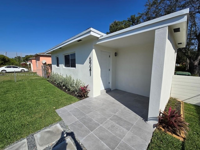 exterior space with a patio and a front lawn