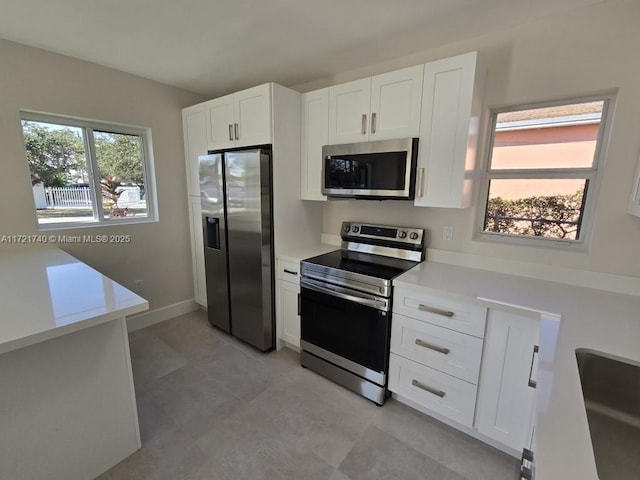 kitchen with sink, white cabinets, and stainless steel appliances