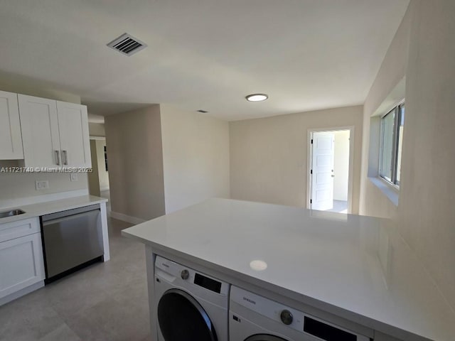 clothes washing area featuring washer and dryer