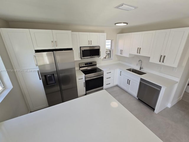 kitchen featuring white cabinets, stainless steel appliances, and sink