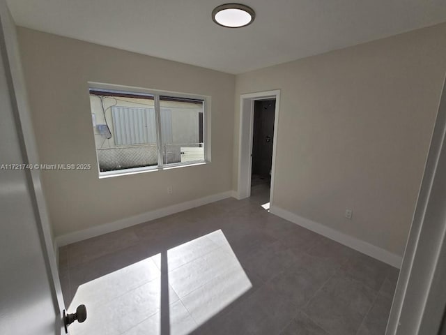 unfurnished bedroom with dark tile patterned flooring