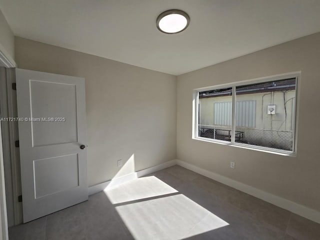 spare room with tile patterned floors