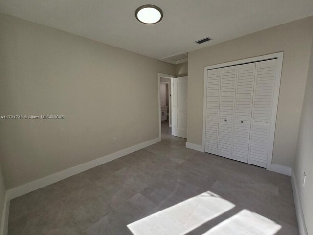 unfurnished bedroom with a closet