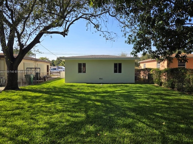 rear view of property featuring a yard