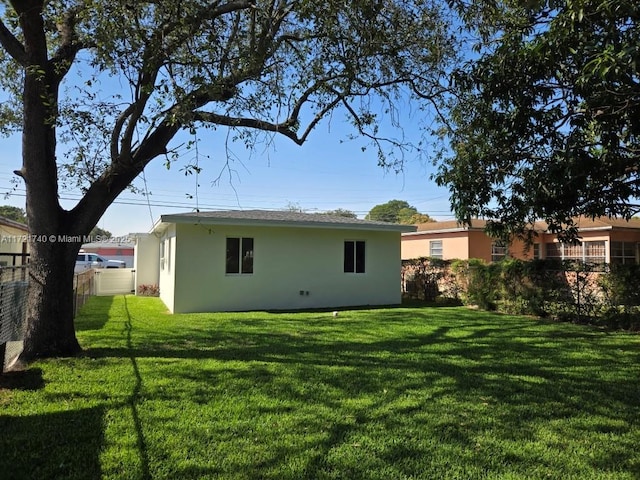 rear view of property with a lawn