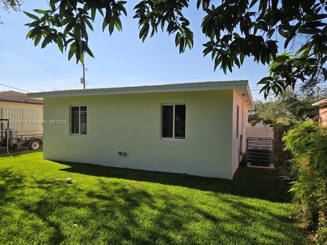 view of side of home with a lawn