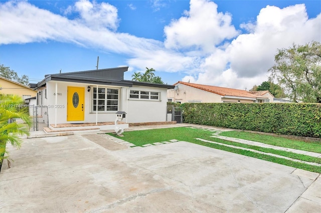 rear view of property with a patio area and a yard