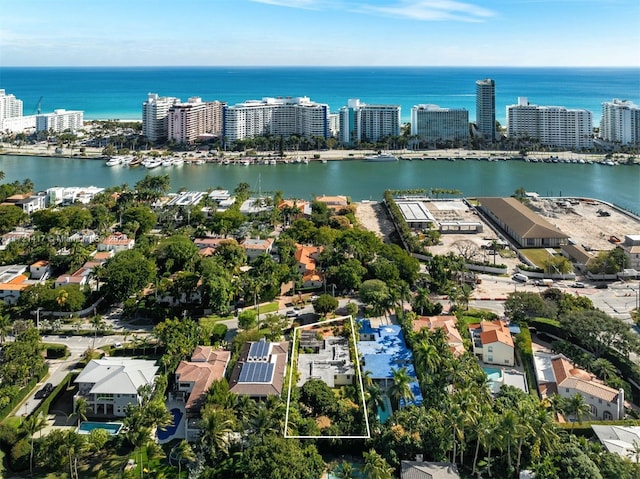 birds eye view of property featuring a view of city and a water view