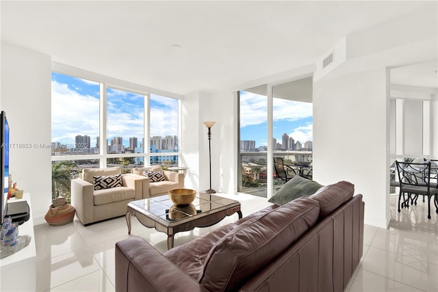 tiled living room featuring a wall of windows