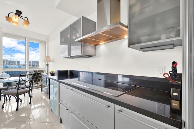 kitchen featuring wall chimney exhaust hood, white cabinetry, light tile patterned floors, and electric stovetop