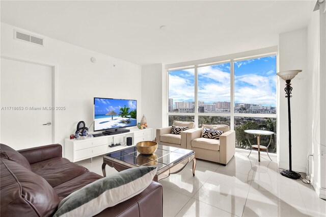 tiled living room featuring expansive windows