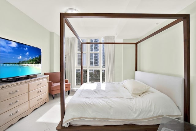 bedroom featuring light tile patterned floors and multiple windows