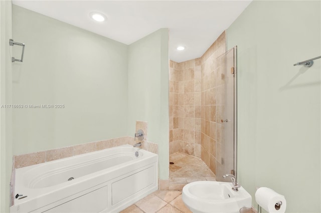 bathroom featuring tile patterned floors, separate shower and tub, and a bidet