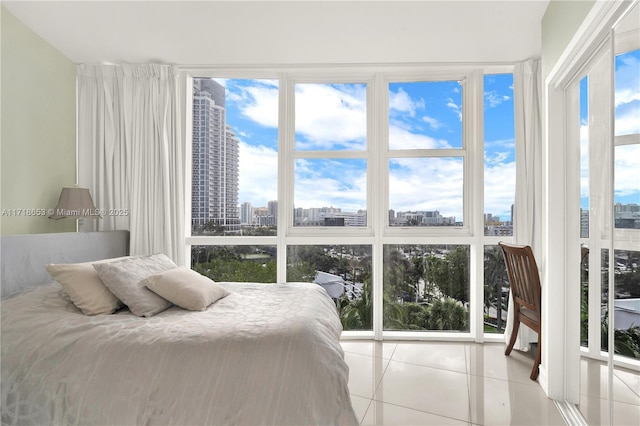 tiled bedroom featuring expansive windows