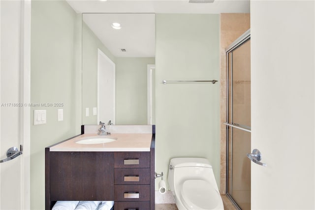 bathroom with vanity, toilet, and an enclosed shower