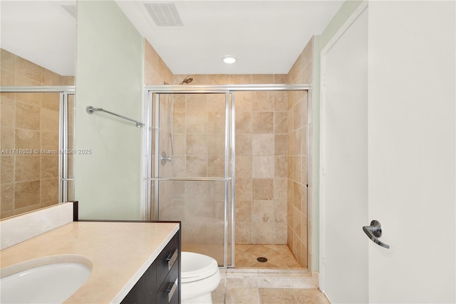 bathroom featuring a shower with door, vanity, and toilet