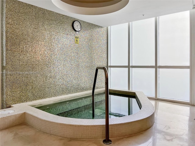 view of pool with an indoor hot tub