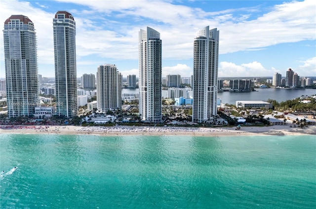 property's view of city featuring a water view and a view of the beach