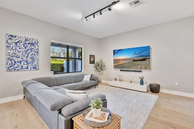 living room featuring hardwood / wood-style flooring and track lighting