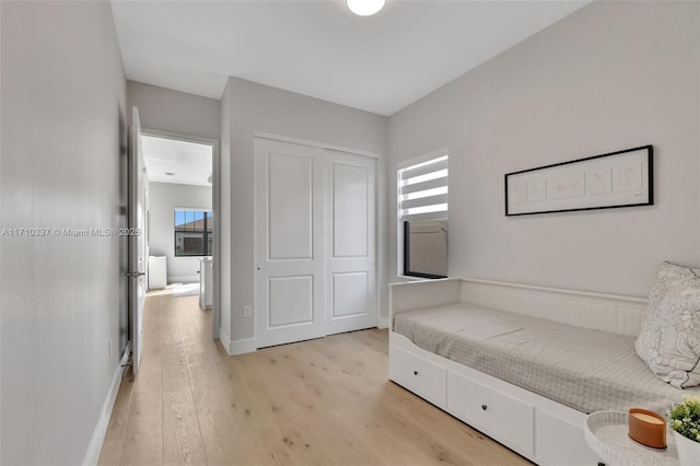 bedroom with a closet and light wood-type flooring