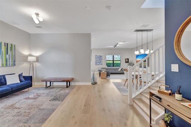 living room featuring hardwood / wood-style floors and track lighting