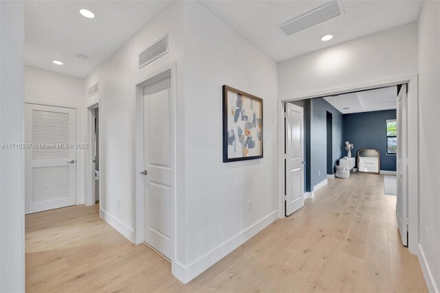 hall with light hardwood / wood-style floors