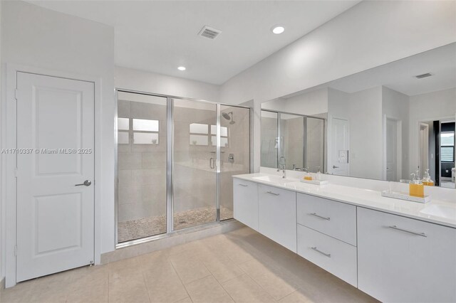 bathroom with vanity, tile patterned floors, and a shower with door