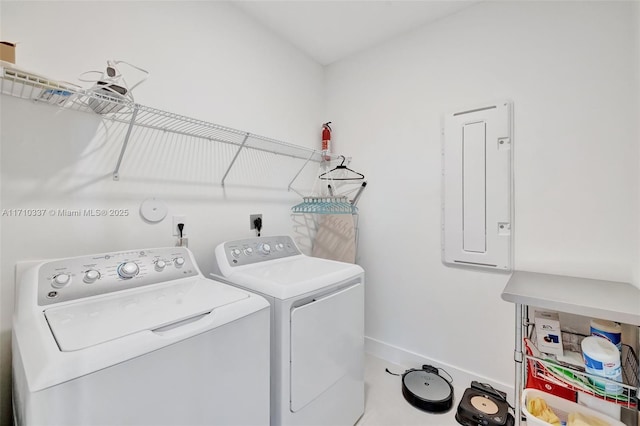 laundry area featuring tile patterned floors, separate washer and dryer, and electric panel