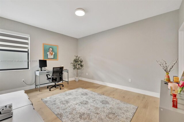 home office with wood-type flooring