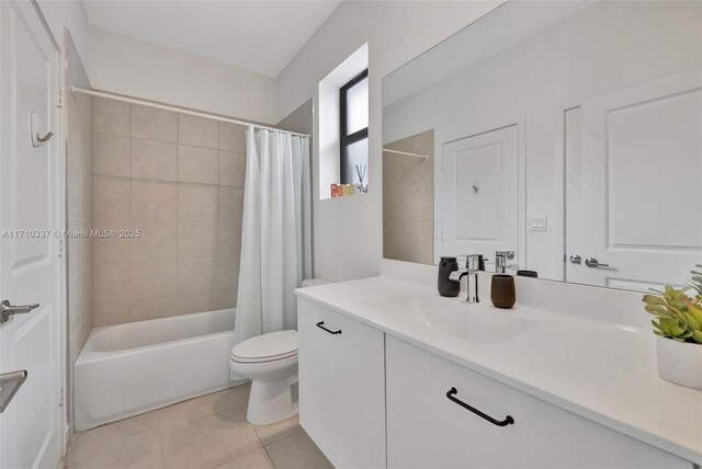 full bathroom with toilet, tile patterned flooring, vanity, and shower / tub combo with curtain