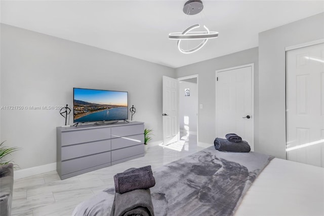 bedroom featuring a notable chandelier