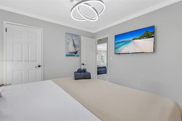 bedroom featuring crown molding and a chandelier