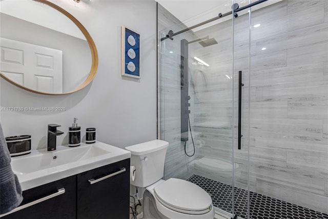 bathroom featuring walk in shower, vanity, and toilet