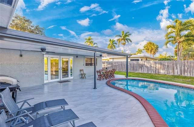 view of swimming pool featuring ceiling fan and a grill