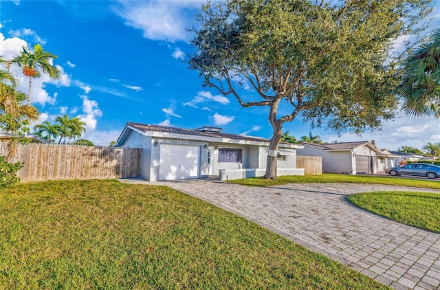 single story home featuring a front yard and a garage