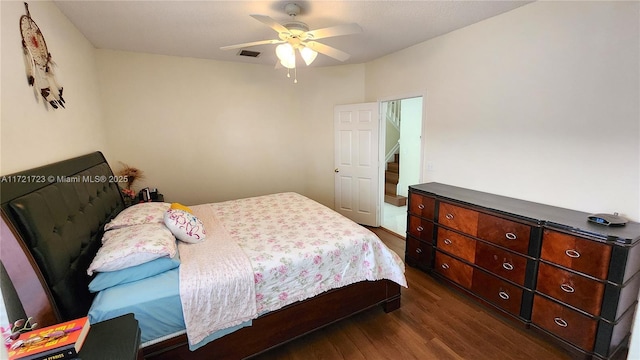 bedroom with dark hardwood / wood-style floors and ceiling fan