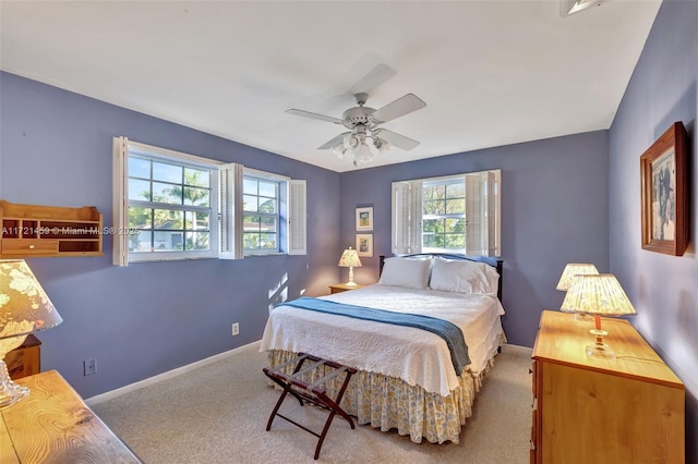 bedroom with light carpet and ceiling fan