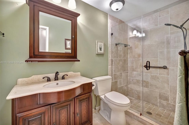 bathroom featuring vanity, toilet, and an enclosed shower