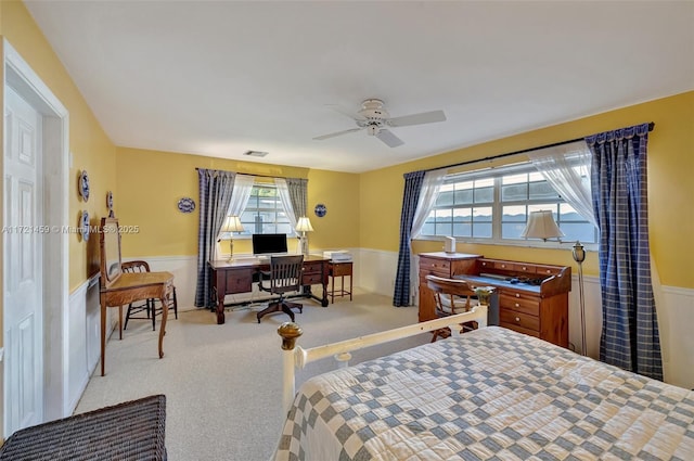 bedroom featuring multiple windows, light colored carpet, and ceiling fan