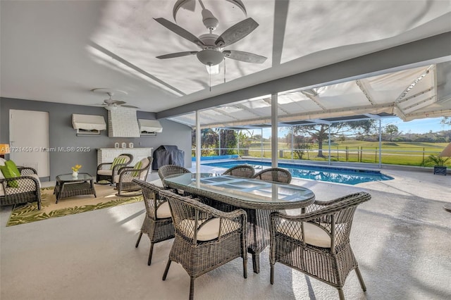 sunroom featuring a wall mounted air conditioner, a pool, and ceiling fan